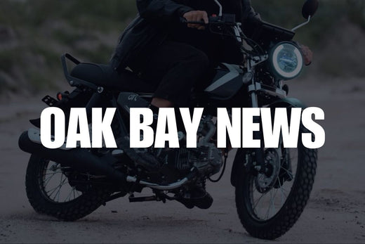 Oak Bay News logo displayed in front of a person riding an Ori Calypso motorcycle.